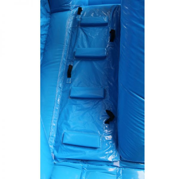 Closeup of a blue bouncy castle climbing wall.