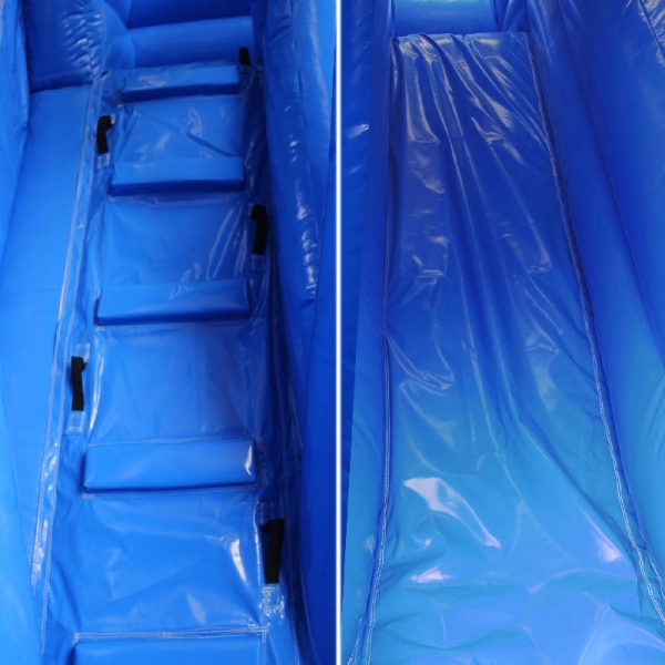 Closeup of a blue bouncy castle climbing wall and a slide.