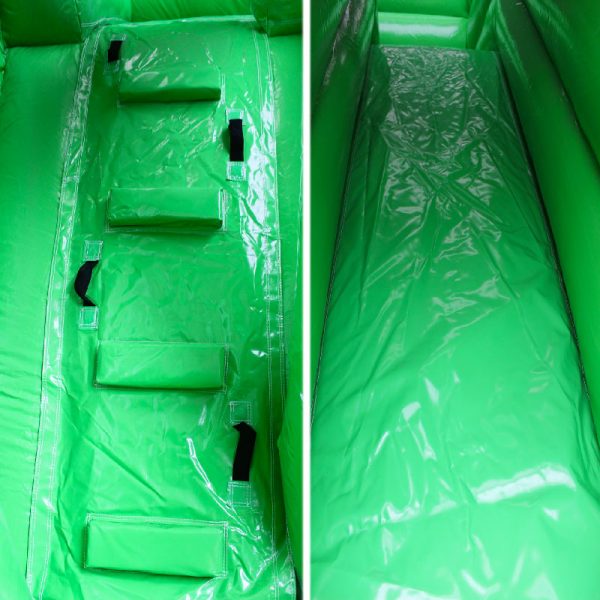 Closeup of a green bouncy castle climbing wall and a slide.